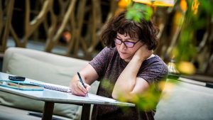 A woman taking notes in a notebook